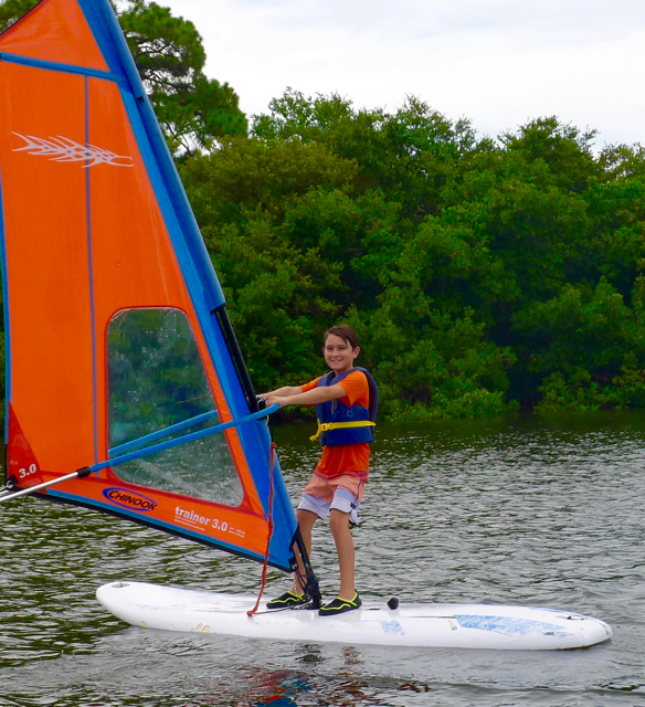 Boy windsurfing at a watersports summer camp in St. Petersburg, Florida